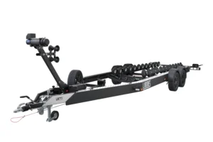 The PP35-8825 TORPEDO trailer is a black boat trailer with multiple rollers, two axles, a front winch, a spare tire, and a sturdy frame, designed for transporting boats. Pictured on a white background.
